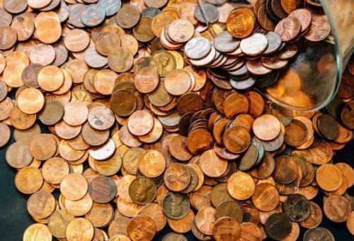 coins spilling out a jar